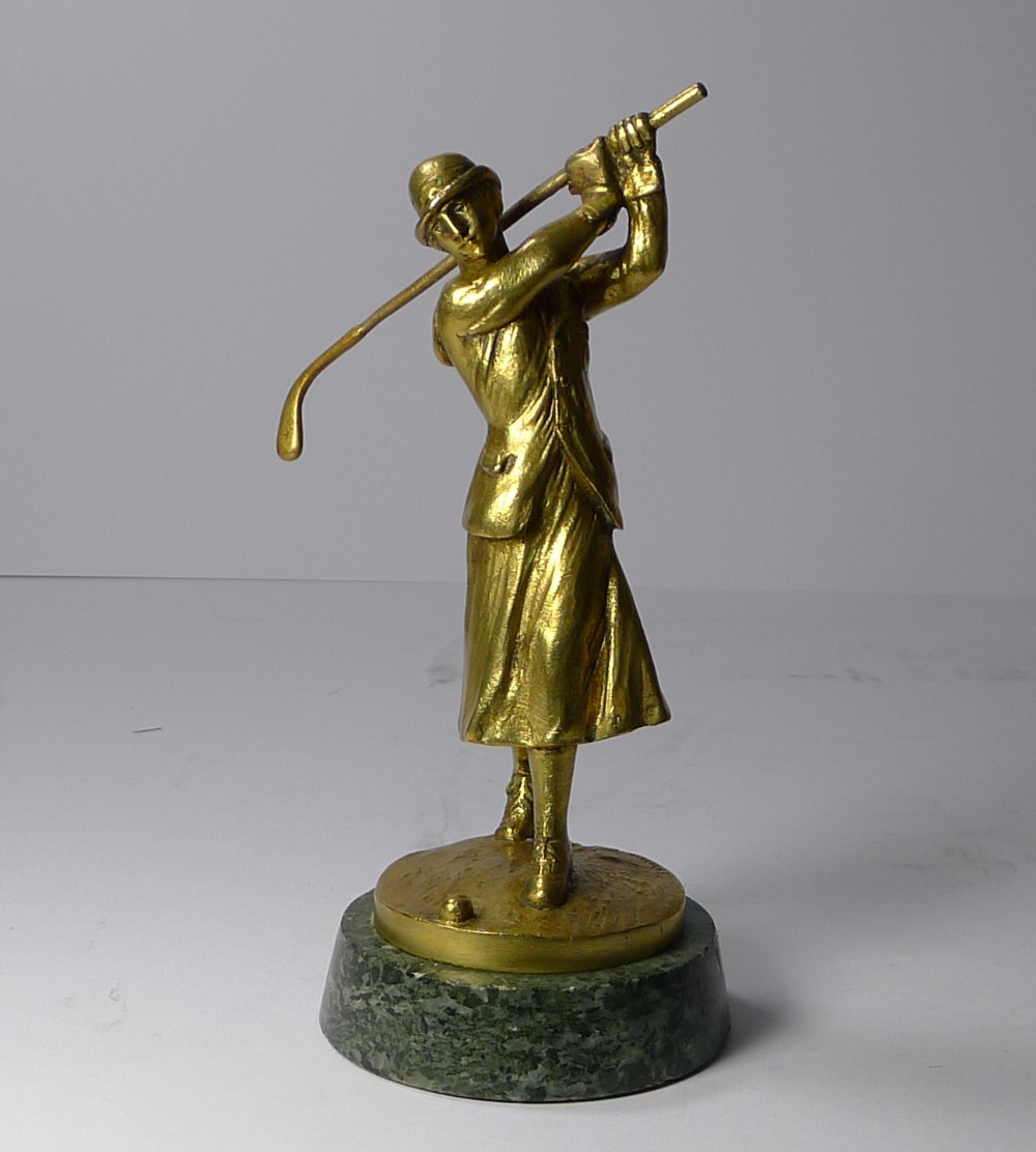 an art deco bronze car mascot in the from of a lady golfer jose dunach