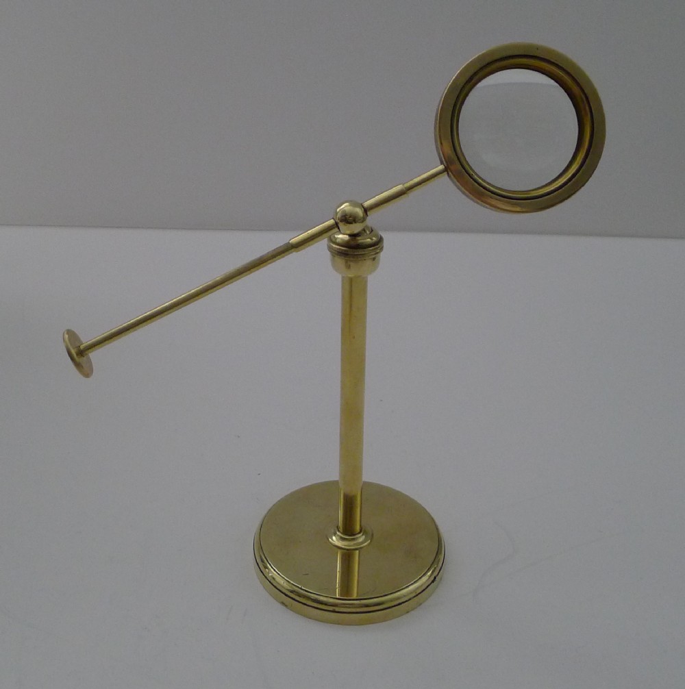 english edwardian brass pivoting magnifying glass on stand c1900